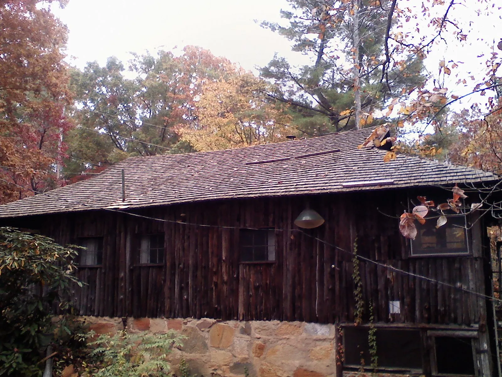 Weathered wood shake roof on a rustic board sided cabin in Round Top